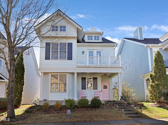 view of front of house featuring a balcony