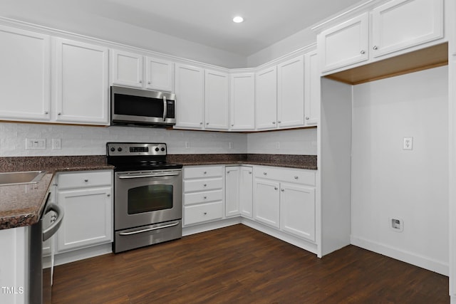 kitchen featuring white cabinetry, dark wood-type flooring, and appliances with stainless steel finishes