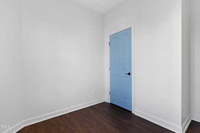 empty room with dark hardwood / wood-style floors