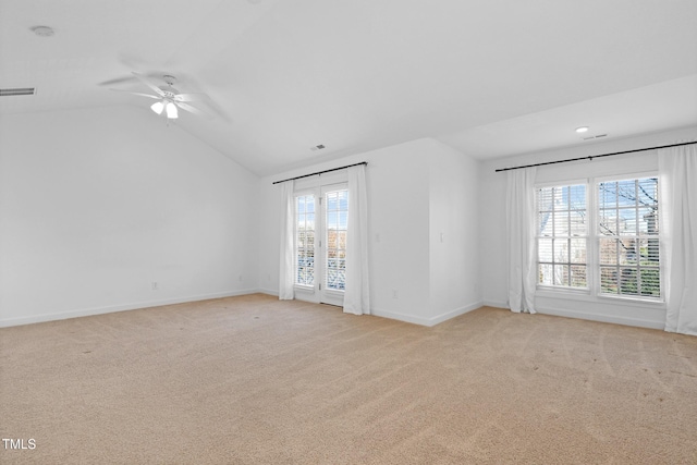 carpeted empty room with plenty of natural light, ceiling fan, and lofted ceiling