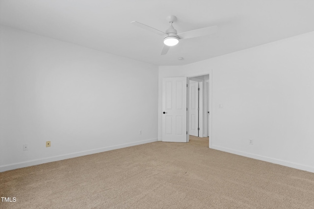 unfurnished room with ceiling fan and light carpet