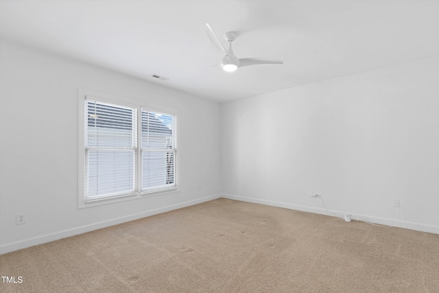 unfurnished room with ceiling fan and carpet