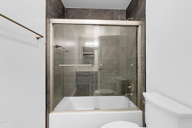 bathroom featuring shower / bath combination with glass door and toilet