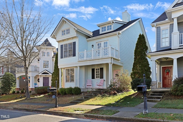 view of front of home with a porch and a balcony