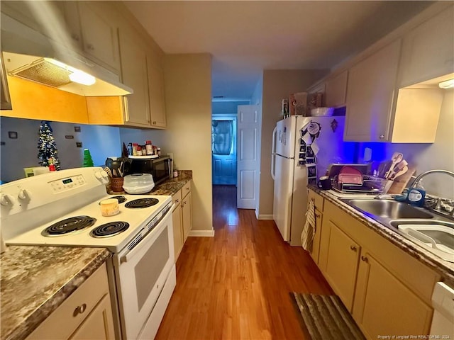 kitchen with white appliances, light hardwood / wood-style floors, and sink