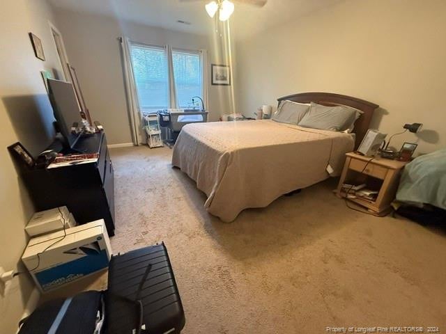 bedroom featuring ceiling fan and light carpet