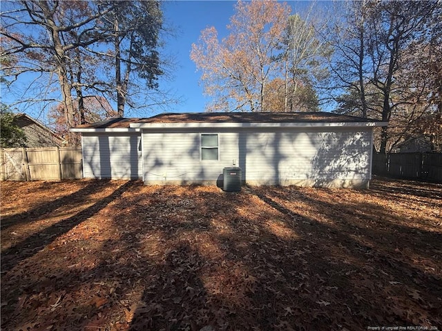 rear view of property featuring central AC