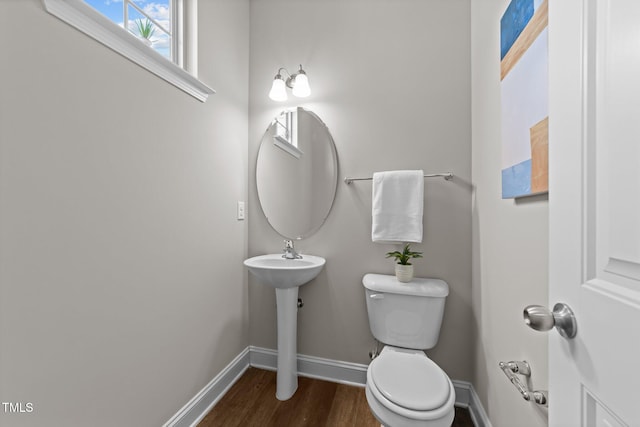 bathroom featuring sink, wood-type flooring, and toilet