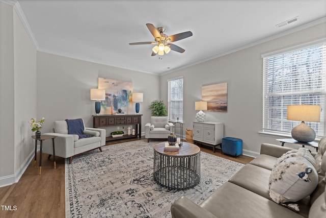 living room featuring hardwood / wood-style floors, crown molding, and ceiling fan