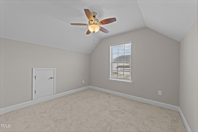 additional living space featuring ceiling fan, lofted ceiling, and light carpet