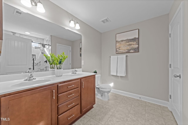 bathroom with vanity, a shower, and toilet