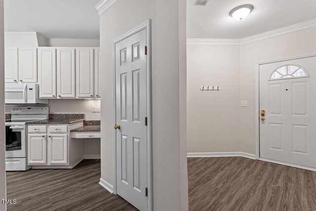 524 Glenolden Ct, Cary, NC 27513 - kitchen with white appliances, dark wood-style floors, white cabinets, crown molding, and dark stone counters