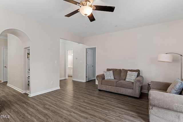living room featuring dark hardwood / wood-style floors and ceiling fan