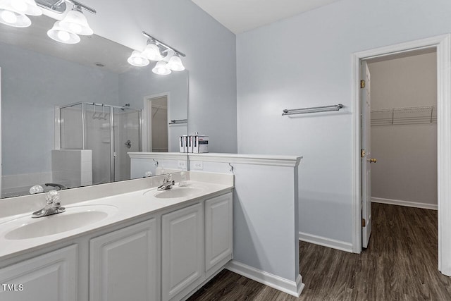 bathroom with vanity, wood-type flooring, and walk in shower