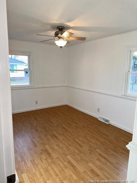 empty room featuring hardwood / wood-style floors and ceiling fan