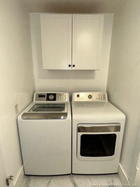 laundry room with cabinets and separate washer and dryer