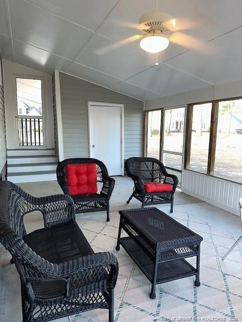 sunroom featuring ceiling fan, a healthy amount of sunlight, and lofted ceiling