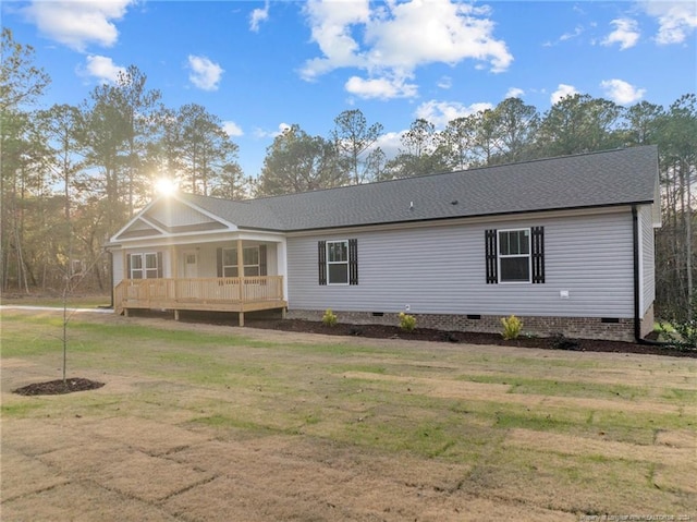 back of property with a yard and a wooden deck