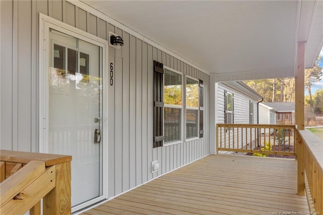 wooden terrace featuring covered porch