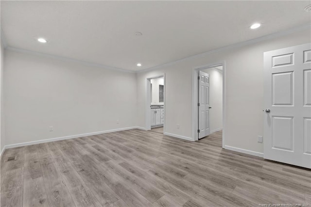 empty room featuring light hardwood / wood-style floors and crown molding