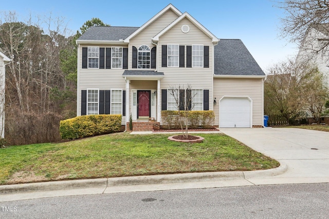 colonial inspired home with a garage, a front lawn, concrete driveway, and roof with shingles