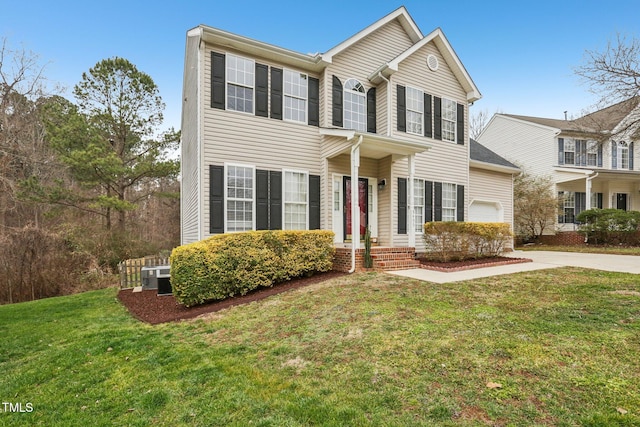 view of front of house with a garage, a front yard, cooling unit, and driveway