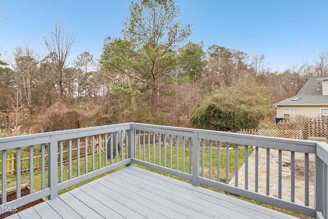 wooden terrace with a lawn