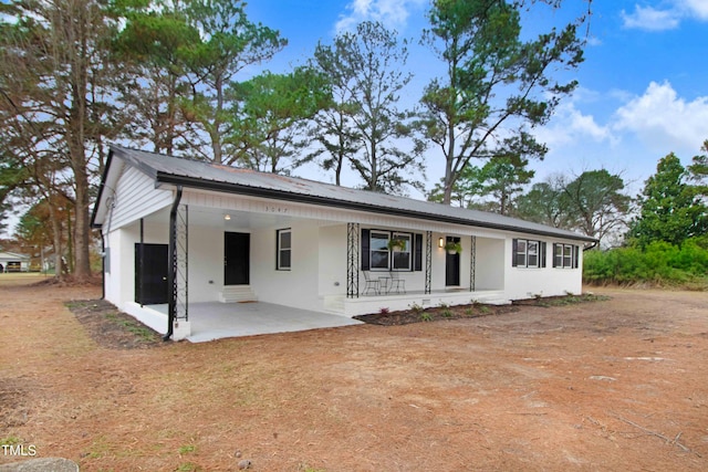 single story home with a porch and a patio