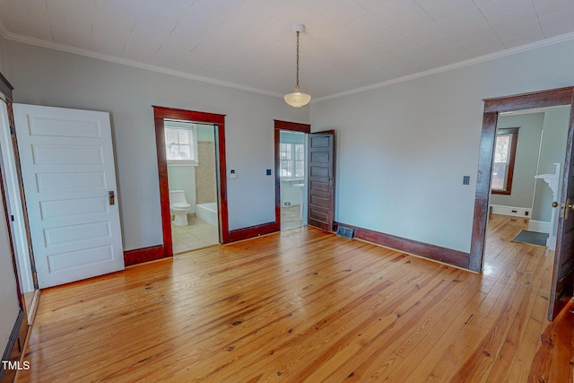 interior space with crown molding and light hardwood / wood-style flooring