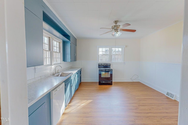 kitchen featuring light wood-type flooring, blue cabinets, sink, dishwasher, and black range with electric stovetop