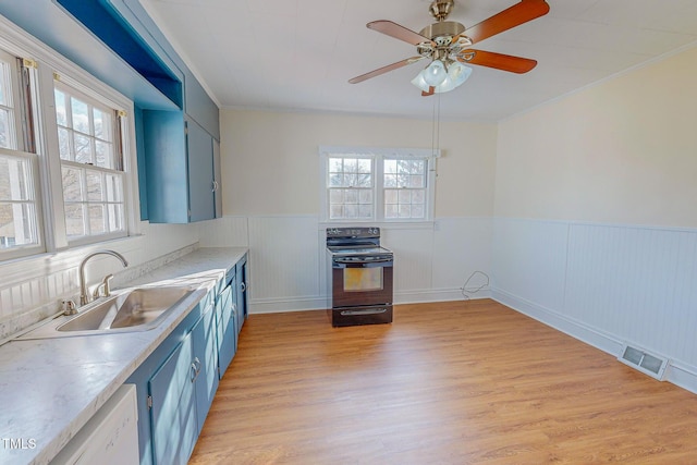 kitchen featuring plenty of natural light, black electric range oven, light hardwood / wood-style floors, and blue cabinets