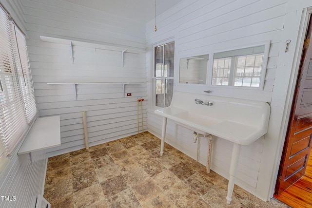 bathroom featuring wooden walls