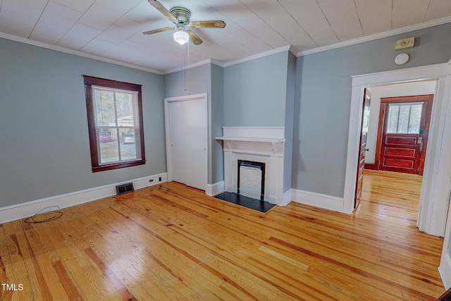 unfurnished living room with ceiling fan, a healthy amount of sunlight, light wood-type flooring, and ornamental molding