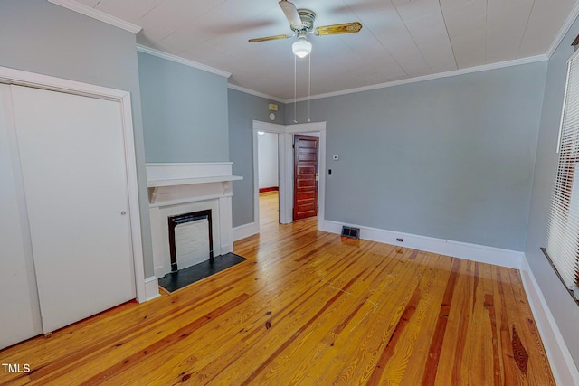 unfurnished living room with hardwood / wood-style floors, ceiling fan, and ornamental molding