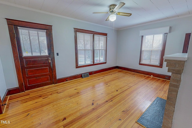 entrance foyer with crown molding, light hardwood / wood-style flooring, and ceiling fan