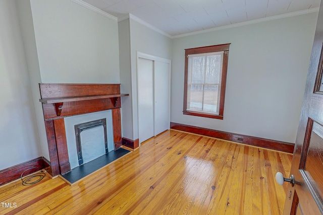 unfurnished living room featuring light wood-type flooring and crown molding