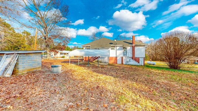 rear view of house featuring a carport