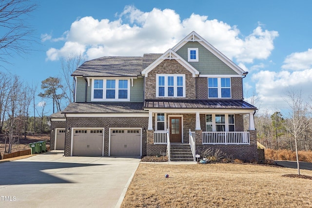 craftsman inspired home with a front lawn, covered porch, and a garage