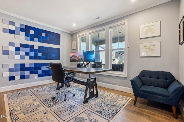 office with ornamental molding and hardwood / wood-style floors