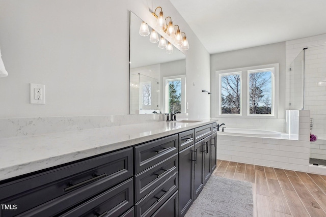 bathroom featuring separate shower and tub and vanity