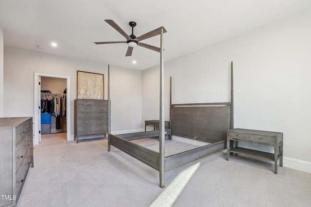 bedroom featuring a closet, a walk in closet, and ceiling fan