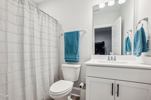 bathroom featuring toilet and vanity