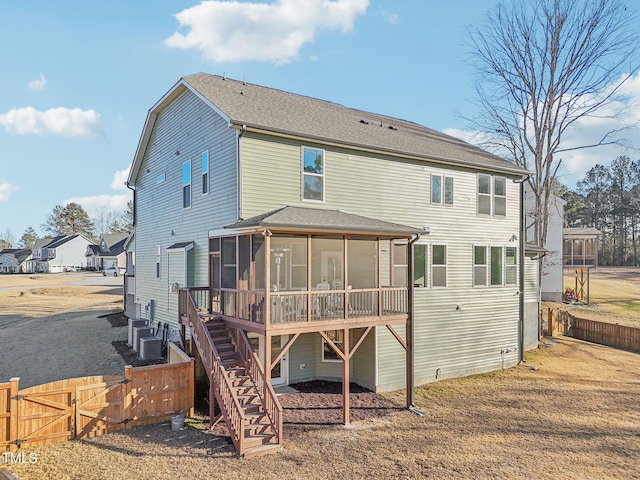 back of house featuring a sunroom