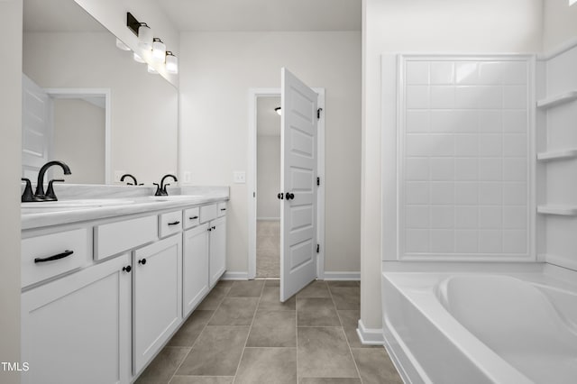 bathroom with vanity, a tub to relax in, and tile patterned floors