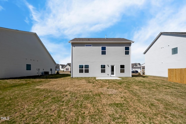 rear view of property with a lawn, central AC, and a patio