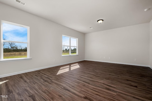 spare room featuring dark hardwood / wood-style flooring