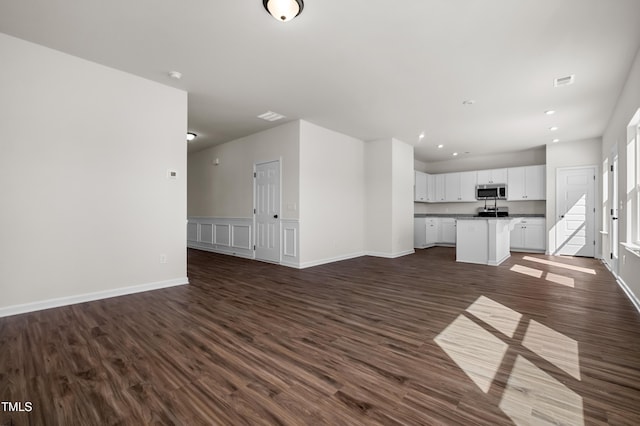 unfurnished living room featuring dark wood-type flooring