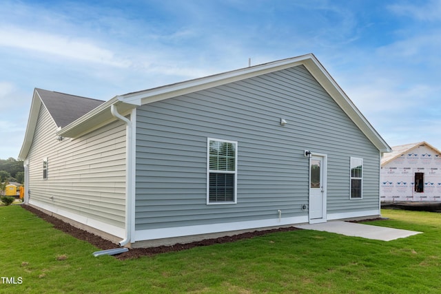 rear view of property with a yard