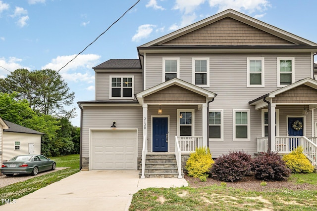 view of front of house featuring a porch and a garage