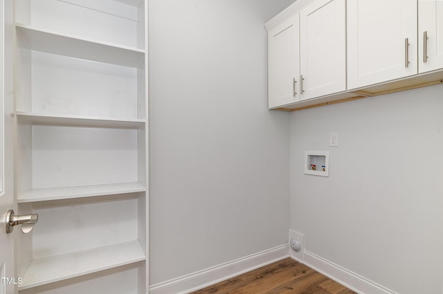 laundry room featuring dark hardwood / wood-style flooring, cabinets, and hookup for a washing machine